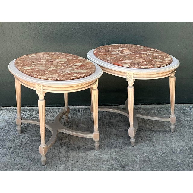 Elevate your interior with this sophisticated pair of French Neoclassical-style side tables. Each table features a...