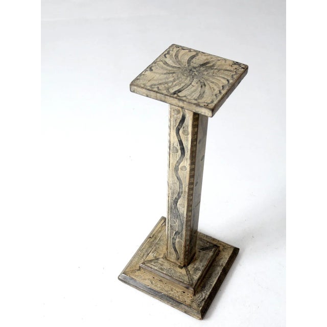 This is an early 20th century vintage pedestal stand. The folk art wooden stand features a swirl and dot pattern hand-...