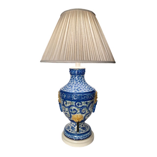 A beautiful, large antique ceramic lamp, hand-painted blue and white with colorful floral motifs, yellow lion heads, iron...