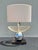 A striking vintage sculptural table lamp featuring a polished chrome sphere body, architectural chrome neck, and oversized...