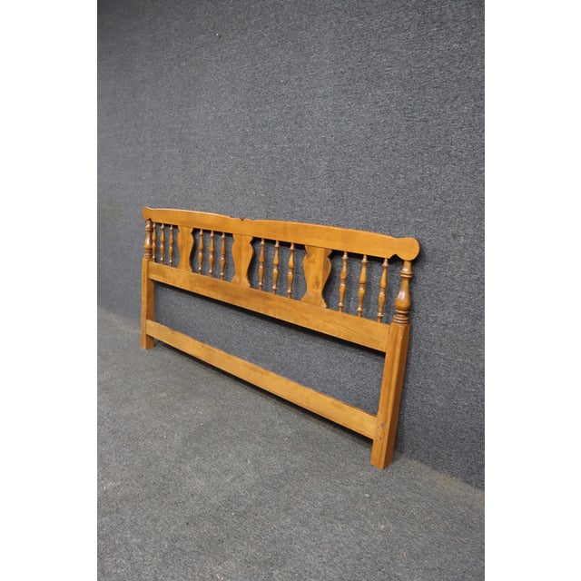 An Ethan Allen king-size headboard crafted in solid maple with the company's classic Bootjack design. Featuring turned...