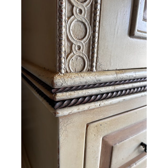 Hand painted armoire with intricate ironwork details and soft gold details. A large Italianate inspired cabinet with...