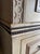 Hand painted armoire with intricate ironwork details and soft gold details. A large Italianate inspired cabinet with...