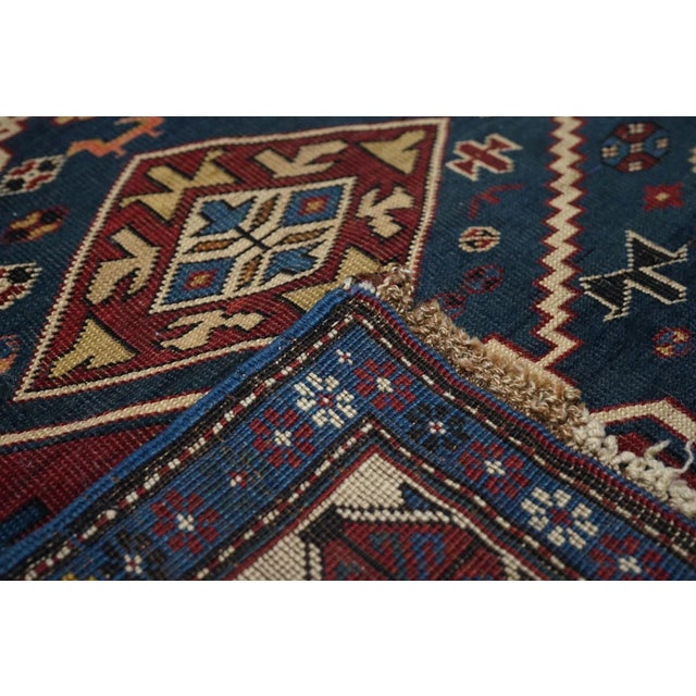 With a beige wool warp more often attributed to Kuba in the eastern Caucasus, this village Kellegi (long rug) shows three...