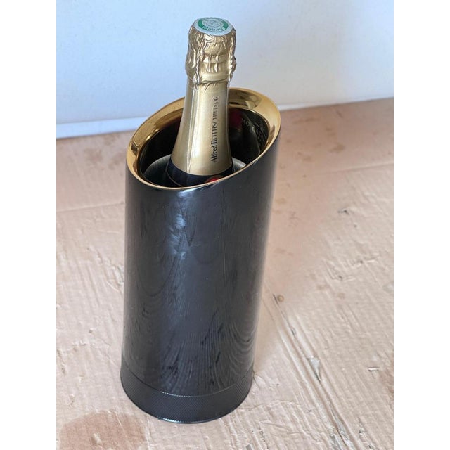 Moet & Chandon Champagne Cooler Metal Black and White Color by Jean Marc Gady. The object is a metal cylinder, which...