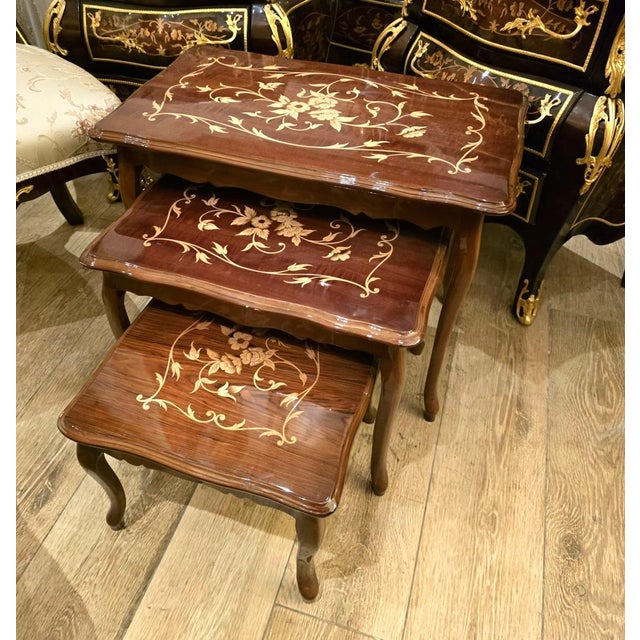 Add timeless European character to your interior with this elegant set of three French-style nesting tables. Crafted...