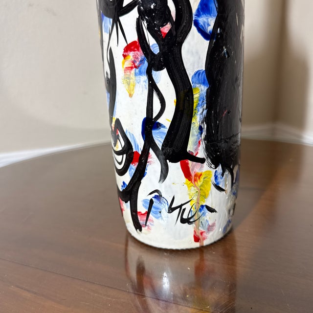 Bring an avant-garde and eclectic edge to your interior styling with this striking hand-painted decorative glass bottle....