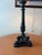 A Haig dual-light table lamp crafted from solid brass with a bronze finish. The lamp features a classical column with...