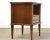 A mid century modern walnut nightstand with a single drawer, sculpted drawer pull and shelf made by Kent Coffey...