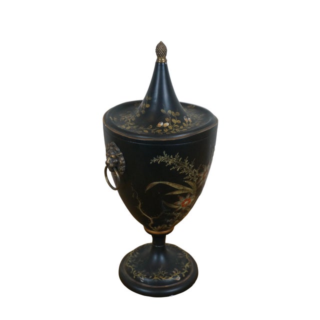 Late 20th century black painted tole ware chestnut mantel urn, painted with foliate and floral designs in gold, white and...
