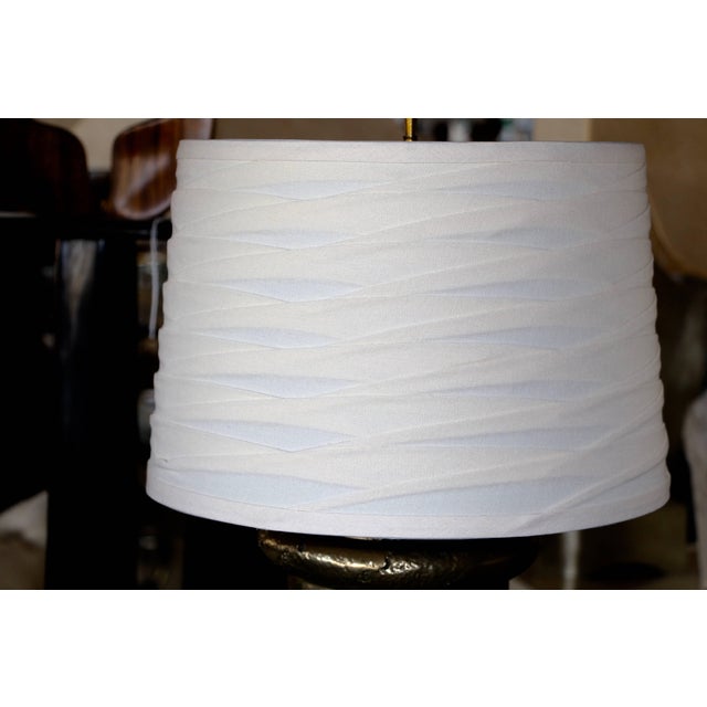 A nice pair of bronze metal coated plaster lamps in the style of Michael Taylor. These are vintage plaster lamps that we...