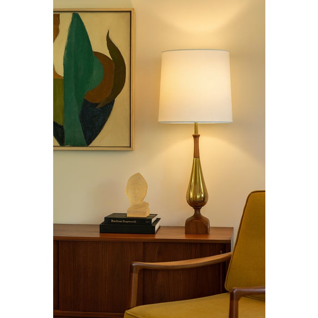 Mid-century Laurel Lamp Company table lamp featuring a sculptural teardrop body in warm walnut and gold-tone chrome/brass...