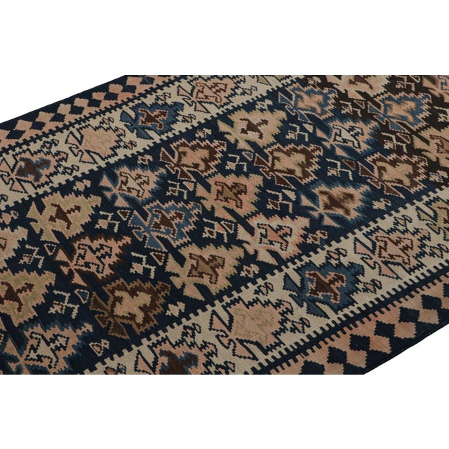 Hand-knotted in wool, circa 1950-1960, this 4x9 vintage Afghan tribal rug features all over geometric patterns in playful...