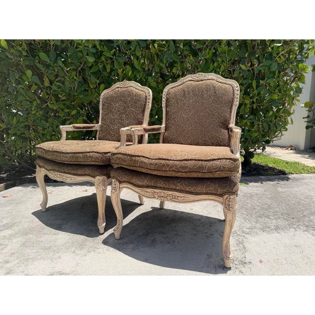 A well-built pair of vintage Fairfield bergere lounge chairs in the Louis XV taste. These chairs feature carved hardwood...
