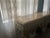 This gorgeous console table is a Baroque Revival / Rococo Revival in style. It was manufactured during the 1990s. This...