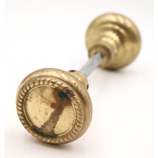 Vintage passage braided door knobs made of brass with a polished finish. Good condition with heavy surface wear from prior...