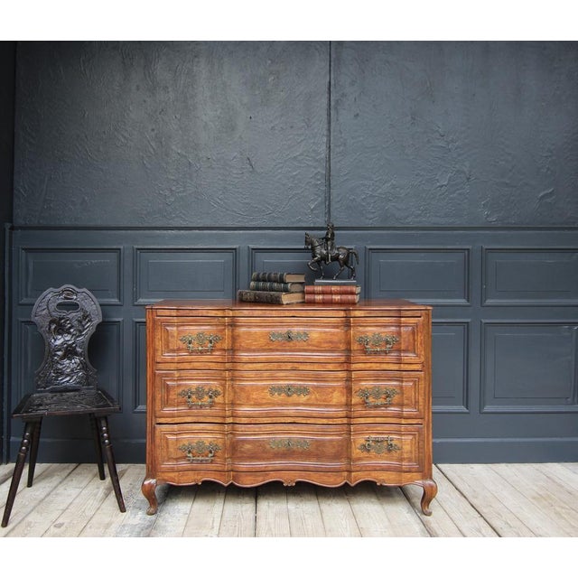 Chest of drawers "en arbalète" in Louis XV style. Circa 1st half of the 19th century. Made of solid cherry wood. On a...