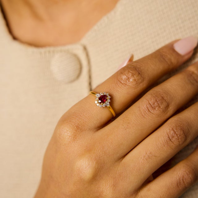 This vintage ruby and diamond cluster ring is a refined expression of warmth, color, and timeless design. At its center...