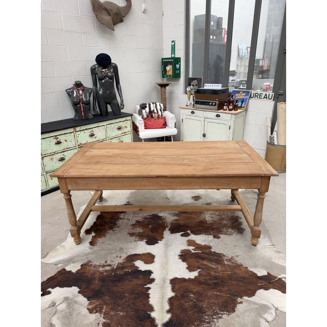 This antique country table made of solid cherry wood has been fully restored. It features a beautiful tabletop and a solid...