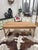 This antique country table made of solid cherry wood has been fully restored. It features a beautiful tabletop and a solid...