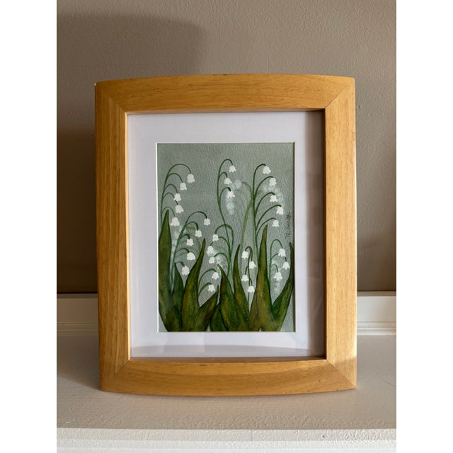 Graceful arches of lily of the valley emerge from layered green washes, their delicate white bells floating against a...