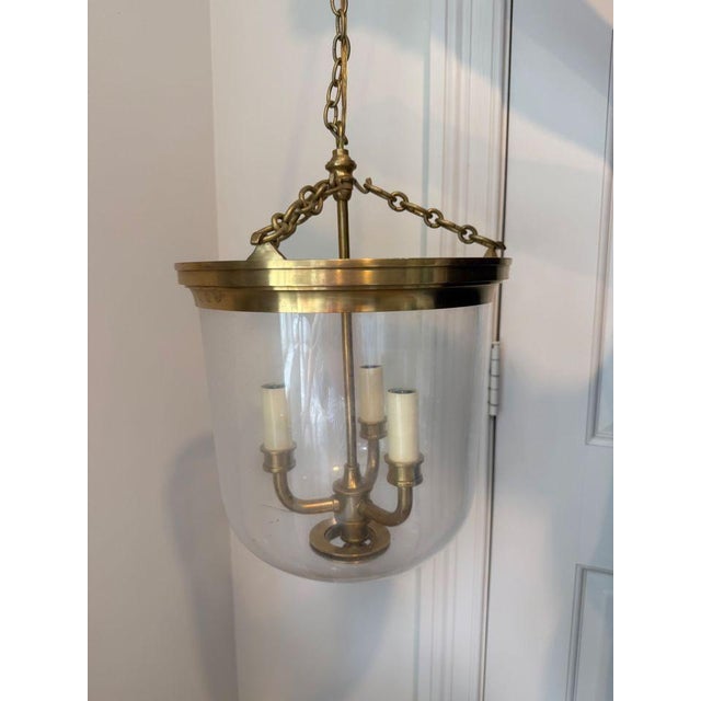 The Merchant Fixture by Visual Comfort is a classic lantern-style fixture in antique brass. This simple pendant is...