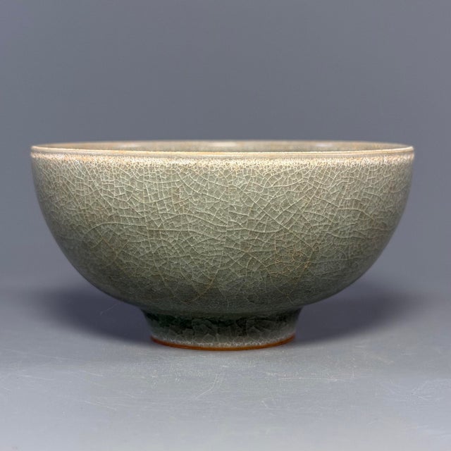 Fine antique Chinese celadon bowl featuring subtle floral‑relief ornament at interior base. Finely crackled muted green...