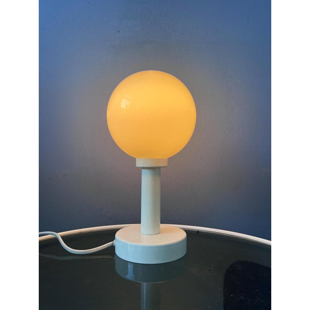 Beautiful mid-century table or bedside lamp featuring an elegant opaline glass shade. The softly diffused glass creates a...