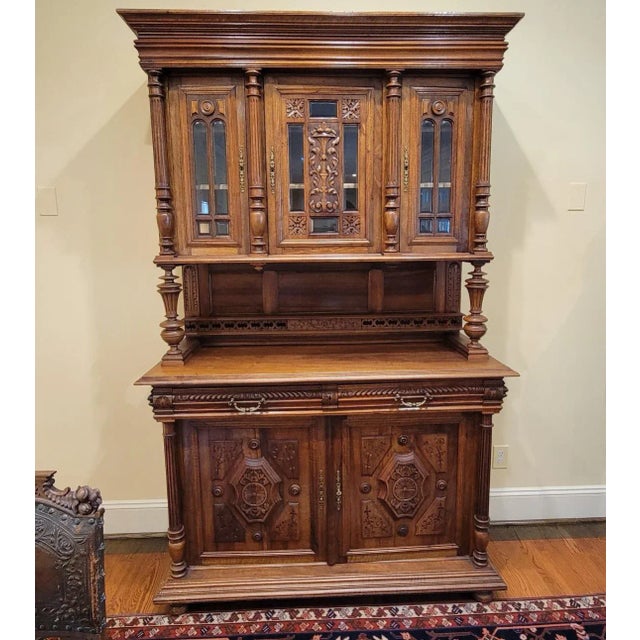 19th C Belgian hand carved walnut cupboard. Locks and comes with original key. Glass in doors are original and beveled....