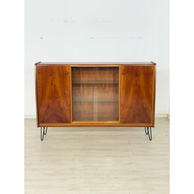 For sale is this elegant mid-century highboard, a true highlight for vintage furniture enthusiasts. As you can see in the...