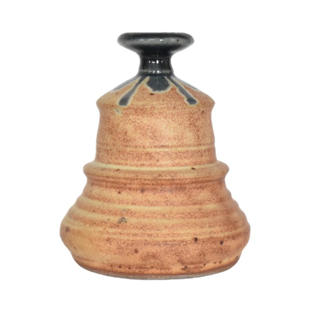 A vintage stoneware pottery hand-thrown narrow-neck vase, with a rust glaze and a blue-grey detail at the top. 4"x5"....