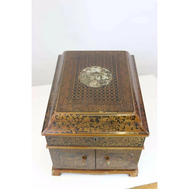 Wonderful example of a 19th century English painted chinoiserie penwork traveling box, black background with gold and...