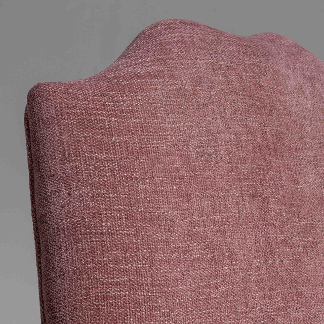 This piece presents as a armchair, distinguished by whitewashed carved wood frame, dusty rose/mauve upholstery. It was...