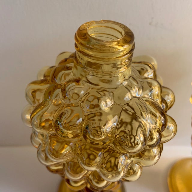 Pretty set of two vintage glass bottles with a grape bunch design. Probably used as perfume bottles or salt and pepper...