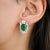 Elevate your style with these stunning Oval 5.04 ctw Emerald and Earth-Mined Diamond Cluster Stud Earrings. Featuring a...