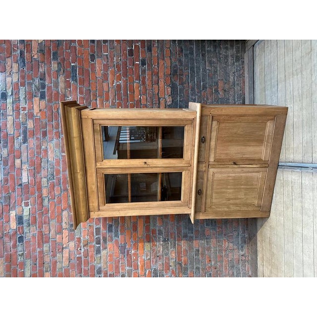 This raw beech dresser has been completely restored. It consists of an upper section with two glass doors opening onto two...