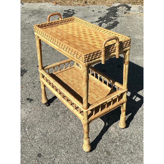 Bring a touch of coastal charm to your home with this exquisite vintage Serena & Lily rattan bar cart. Handwoven with...