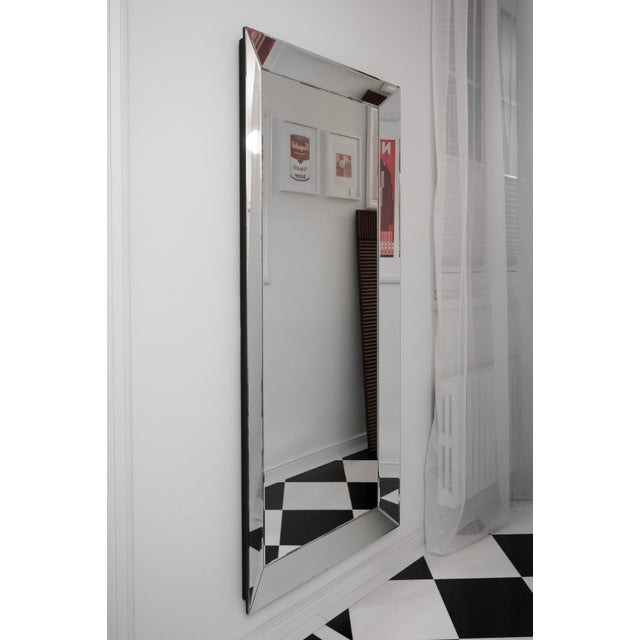 Elegant mirror with faceted glass and a wide mirrored frame. Its clean, minimalist form with art deco touch is really...