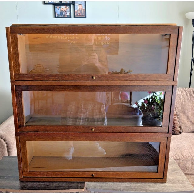 The antique Globe Wernicke 3 Section Oak Barrister Bookcase, manufactured circa 1910, is a stunning piece of furniture...