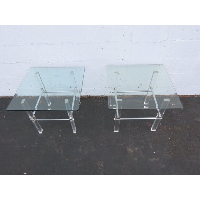 This Hollywood Regency Pair Of Side Tables made of Lucite and glass. These Side Tables have Hollywood Regency Mid Century...