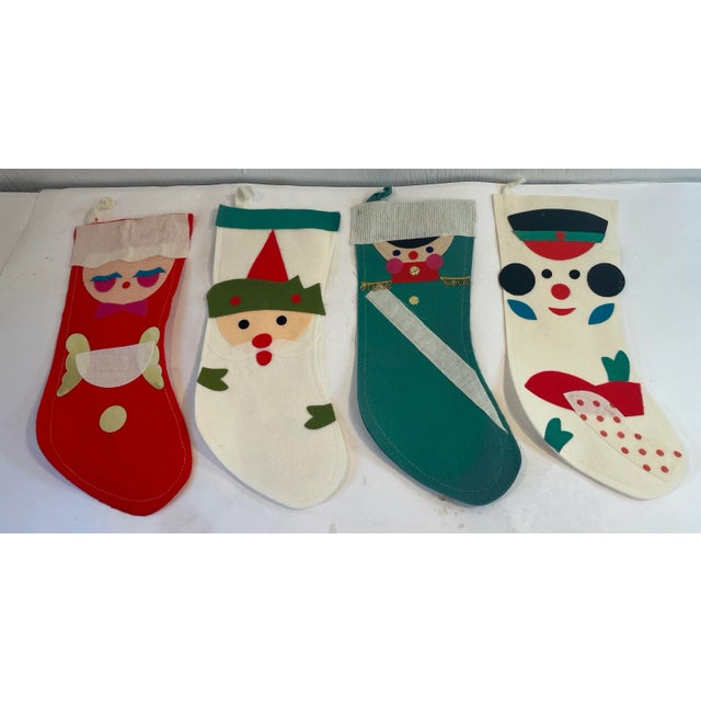 Cute set of four holiday Christmas stockings with appliqué design.