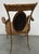 Elegant pair of Regency-style armchairs crafted of faux tortoiseshell-decorated bamboo with woven rattan seats and oval...
