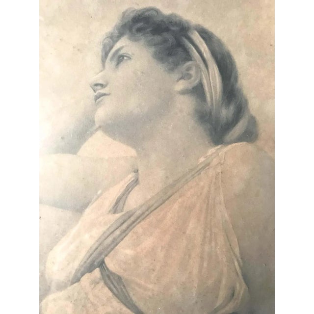 Charming engraving of a young woman signed Henry Ryland. It represents a young woman in profile, with her hair tied up and...