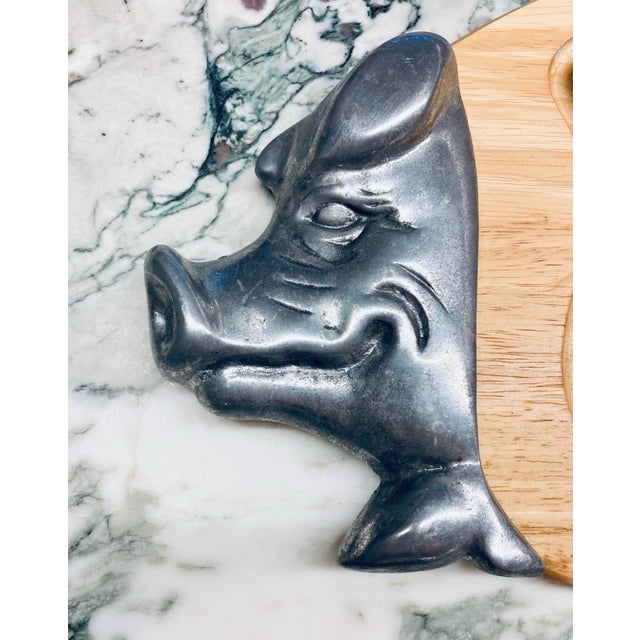 A striking and sculptural serving piece by Studio Nova in California, this pig shaped carving and serving board blends...