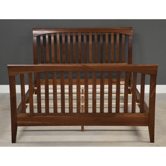 A solid cherry modern queen size bed made by Ethan Allen American Impressions. Made in USA. Circa 1990’s. Footboard 63.75”...