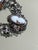 Vintage cameo filigree link bracelet featuring five oval carved cameo panels set within ornate silver-tone openwork...