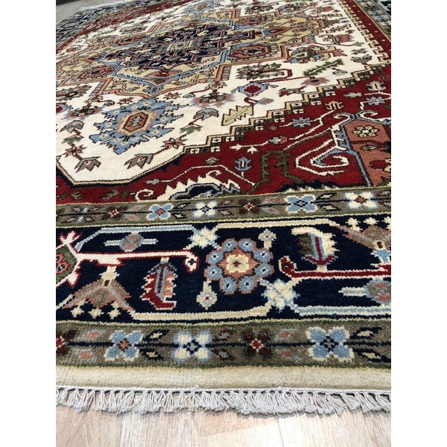 This ivory beige and cream white wool rug features a classic Agra style design suitable for residential floors....