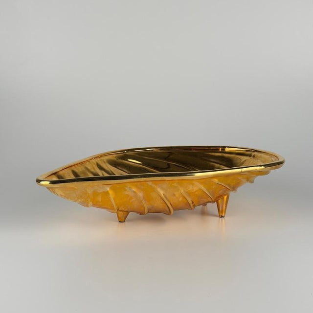 Striking and sculptural, this large centerpiece takes the form of an abstract shell, balancing organic movement with a...