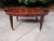 An exceptional Federal style coffee table with extension trays by Baker Furniture Circa 1980s Book-matched mahogany, with...