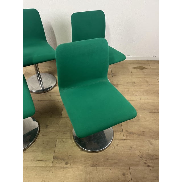 Set of 4 chairs with a steel frame, seat and backrest upholstered in green fabric, made in Italy in the 1970s. The chairs...